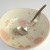 Tsuchime ramen ladle resting in large Japanese bowl